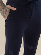 Mens Solid Slim Fit Trackpant with Side Zipper Pockets Drawstring and Knee Print Detail