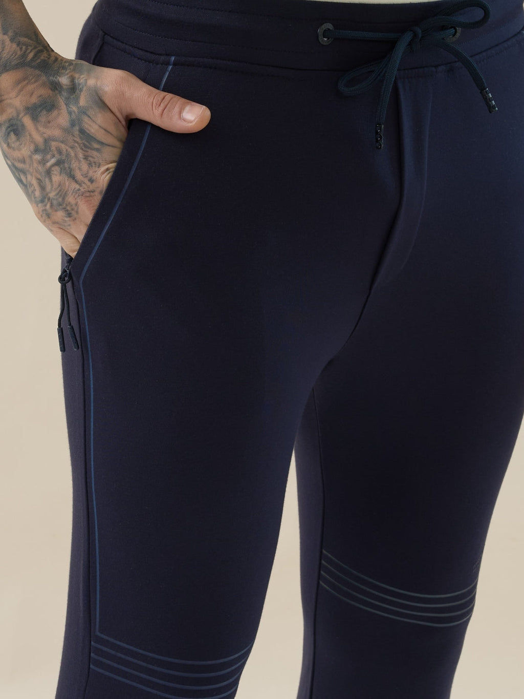 Mens Solid Slim Fit Trackpant with Side Zipper Pockets Drawstring and Knee Print Detail