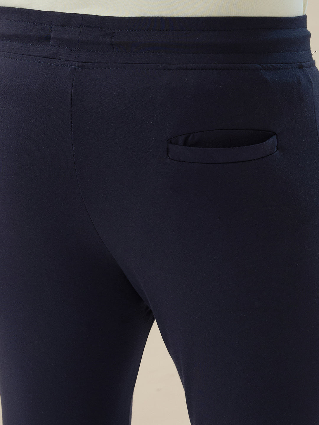 Mens Solid Slim Fit Trackpant with Side Zipper Pockets Drawstring and Knee Print Detail