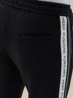 Men's Solid Regular Fit Fleece Trackpant with Side Zipper Pockets and Typography Stripe